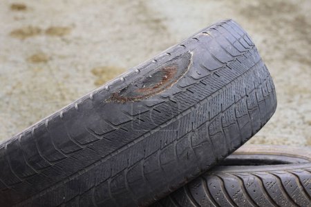 Photo for Old worn damaged tires as pattern of old damaged tires for advertising tire shop or car tire shop - Royalty Free Image