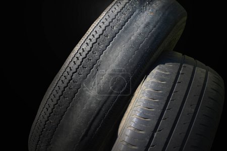 Photo for Old worn damaged tires as pattern of damaged tire for advertising tire shop or car tire shop - Royalty Free Image