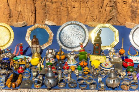 Photo for Multicolored Moroccan craft souvenirs at the market. Teapots and plates , decorations, tagines,, trinkets - Royalty Free Image