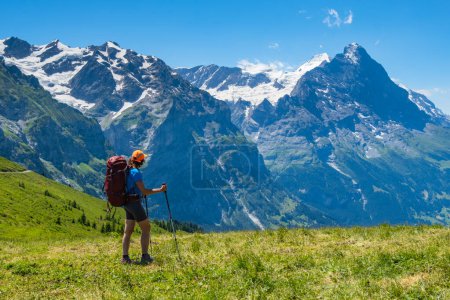 Sporty woman hiking in Switzerland alps. Heathy lifestyle, sport, beauty in nature. Grindelwald valley, Swizz
