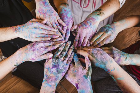 Photo for A group of people with their hands painted in various colors - Royalty Free Image