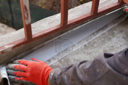 Photo for Installation of waterproofing tape on the floor of the balcony. - Royalty Free Image