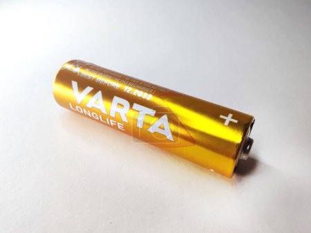 Photo for Varna, Bulgaria - March, 11, 2023: one Varta gold battery on a white background close-up - Royalty Free Image