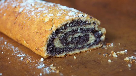 Photo for Poppy seed roll sprinkled with powdered sugar close-up - Royalty Free Image
