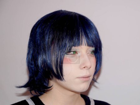 portrait of a sad teenage girl in anime style with blue hair and green eyes, side view