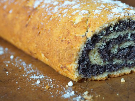 Photo for Close-up of poppy seed roll sprinkled with powdered sugar. - Royalty Free Image