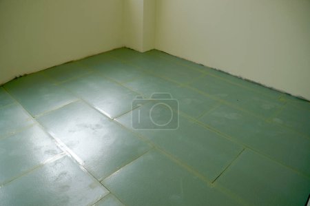 Photo for Preparation for laying laminate flooring, the floor is covered with a laminate underlay. - Royalty Free Image