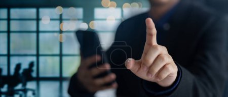 Photo for Modern businessman using smartphone with index finger touch gesture. Embrace digital communication and mobile technology. - Royalty Free Image