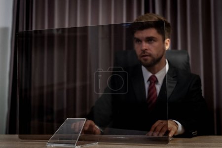 Photo for A futuristic businessman looks at an empty transparent monitor screen, ready to add graphics or pictures. This image is perfect for use in presentations, marketing materials, or website designs. - Royalty Free Image