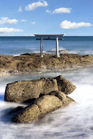 Photo for Stunning photo of a torii gate floating in the ocean at Oarai Isosaki Shrine in Japan. This iconic image is a symbol of Japanese culture and spirituality. - Royalty Free Image