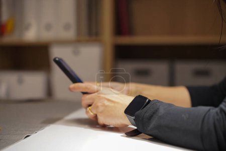 Photo for Close up hands of Asian business woman in black suit working through internet on smartphone at modern office in night time, smart life with digital device, copy space - Royalty Free Image