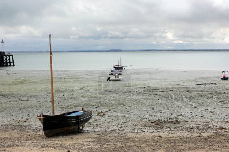Photo for Aground boat in the seabed at low tide in the North of France - Royalty Free Image