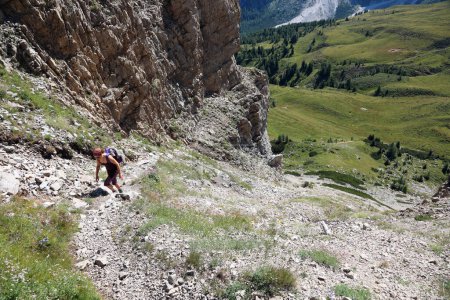 Photo for Young woman walks uphill on the steep trail of the Dolomites on the Italian Alps in summer - Royalty Free Image