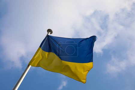 Photo for Yellow and blue flag of Ukraine and white clouds - Royalty Free Image