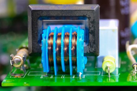 Foto de Mini transformer with copper winding of an electronic circuit of an electrical equipment - Imagen libre de derechos