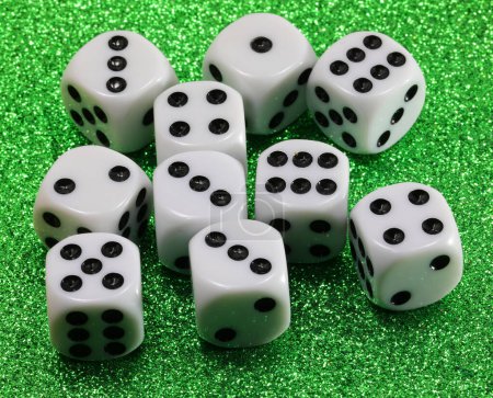 Photo for Many gambling dice on green shiny casino table - Royalty Free Image