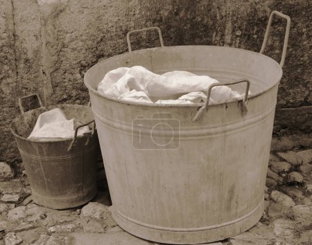 Photo for Bucket and tub for doing the laundry with sepia antiqued effect from the 1920s - Royalty Free Image