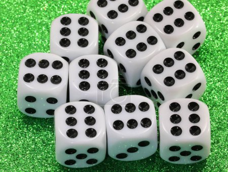 Photo for Many gambling dice on green shiny casino table - Royalty Free Image