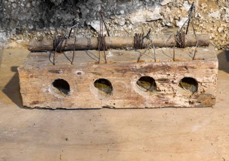 Foto de Four holes of an ancient handmade trap to catch mice in the cellar of the farm - Imagen libre de derechos