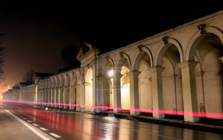 Photo for Red streak left by the car lights and the ancient arcades leading to the Basilica called DI MONTE BERICO in the City of Vicenza in Italy in the rainy night - Royalty Free Image