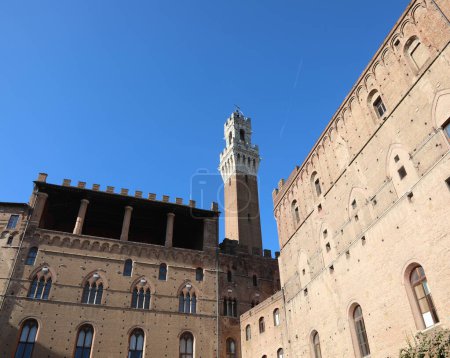Téléchargez les photos : Famous tower of the city of Siena called DEL MANGIA seen from behind and the ancient palaces - en image libre de droit