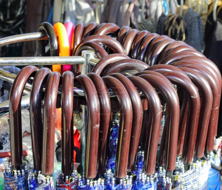 handles of many closed umbrellas for sale in the stall of the bazaar