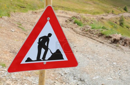 new traffic sign of work in progress in an outdoor construction site during the construction of a road