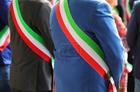 Téléchargez les photos : Maires avec le drapeau tricolore italien lors de la cérémonie officielle avec robe élégante - en image libre de droit