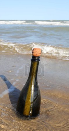 Photo for Beached bottle with secret message closed by a cork - Royalty Free Image