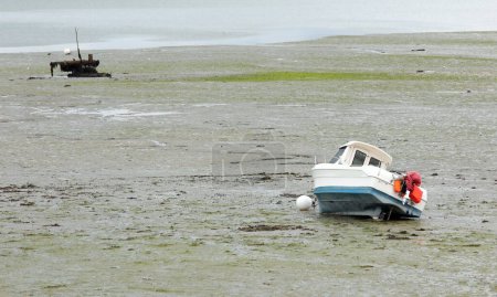 Photo for Beached motorboats at low tide in Brittany in France - Royalty Free Image