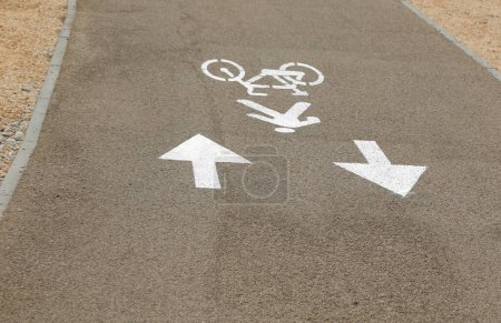 Photo for Signs painted on the ground on the cycle path with two arrows and also pedestrian area - Royalty Free Image
