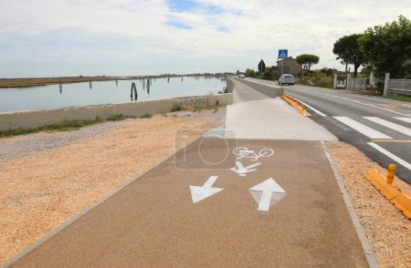 Photo for Signs painted on the ground on the cycle path with two arrows near Venice in Italy - Royalty Free Image