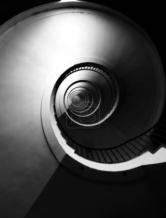 Photo for Spiral staircase seen in perspective with steps going towards infinity - Royalty Free Image