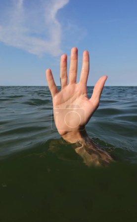 Photo for Five fingers of the hand while drowning in the ocean and asking for help symbol of failure and failure - Royalty Free Image