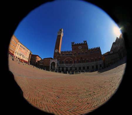 fisheye lens view of the Tower called TORRE DEL MANGIA in the main Piazza of SIENA in central Italy