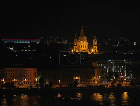 Photo for Night view of St Stephens Church in Budapest capital of Hungary and the reflections on the Danube River - Royalty Free Image