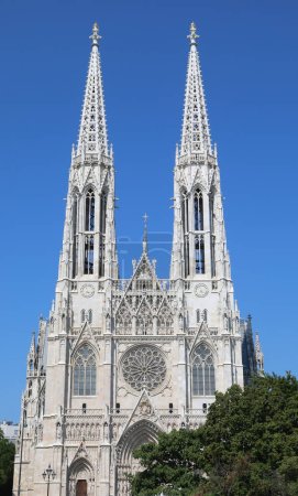 Photo for Two high white bell towers of the VOTIVE CHURCH in Wien in Austria In Central Europe - Royalty Free Image