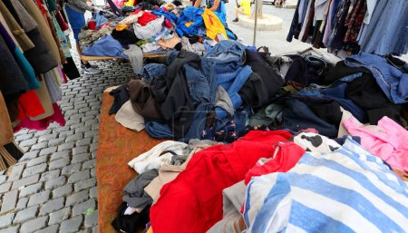 Photo for Many used clothes for sale in the flea and used clothing market where you can find excellent purchasing opportunities - Royalty Free Image