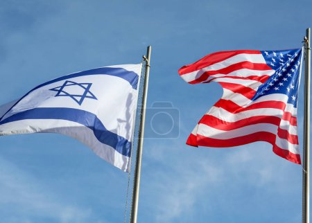 Photo for Two large Israeli and American flags flying in the blue sky - Royalty Free Image