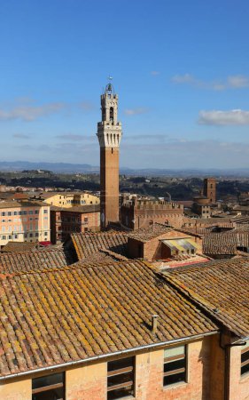 Photo for Civic tower called Torre del Mangia and roofs of the city of Siena in Tuscany in Italy - Royalty Free Image