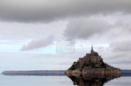 Photo for Reflection on the water of the ancient Abbey of Mont Saint Michel in the Normandy region of Northern France - Royalty Free Image