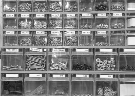 Photo for Shelf with bolts and nuts for repairs and maintenance in the repairmans shop - Royalty Free Image