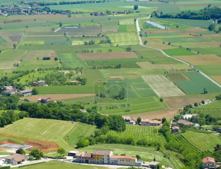 seen from above of the plain with cultivated fields divided into geometric shapes in spring
