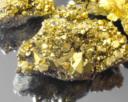 series of golden rocks of various sizes with glittering gold reflections