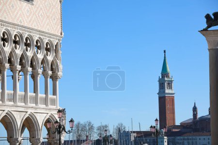 Venice, VE, Italy - February 13, 2024: Corner of Ducal Palace also called Palazzo Ducale and Bell tower of Saint George in venetian lagoon