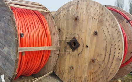BIG High-voltage cable drum also called Electrical conductor reel with red cables in the warehouse