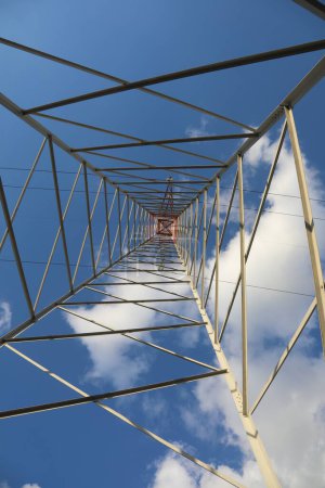 Téléchargez les photos : Pylône avec câbles haute tension pour le transport d'électricité et de nuages blancs sur le ciel - en image libre de droit