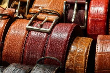 Leather belts handcrafted by artisans with metal buckles are available for purchase