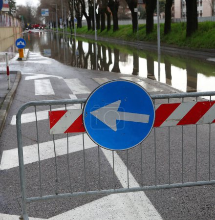 señal de tráfico con flecha de desvío debido a la inundación de la carretera después de la inundación