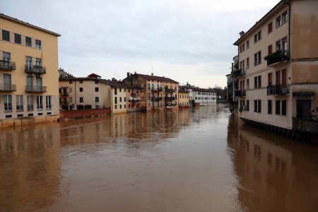 houses on the banks of the swollen river called BACCHIGLIONE in the city Vicenza in Northern Italy during the flood